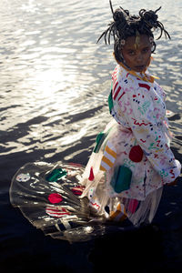 Girl with arms raised in water