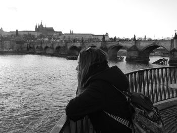 Tourist looking at river in city