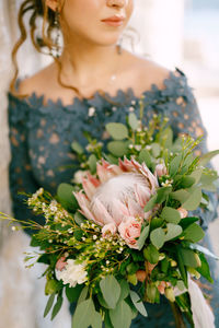 Close-up of woman holding flower bouquet