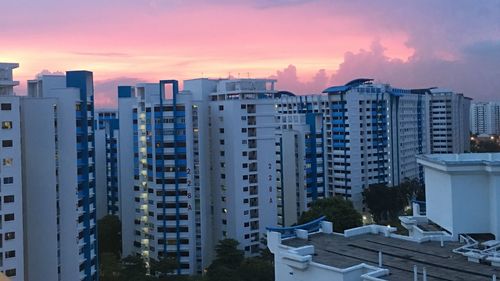 Buildings in city at sunset