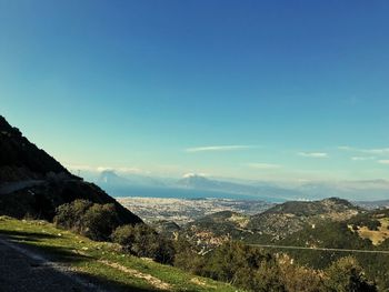 Scenic view of landscape against blue sky