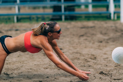 Beach volleyball player hitting the ball