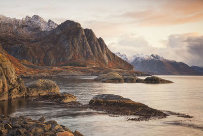 Scenic view of sea and mountains against sky