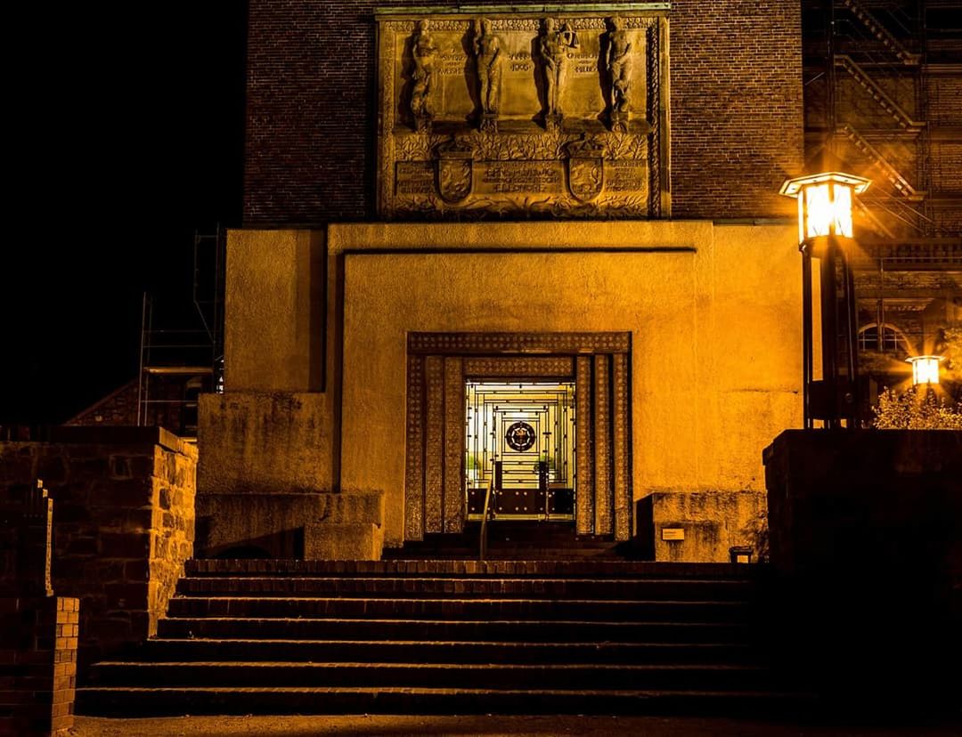 staircase, architecture, built structure, steps and staircases, night, illuminated, building exterior, lighting equipment, no people, building, railing, street light, the way forward, entrance, direction, outdoors, low angle view, city, religion, belief