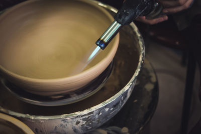 The potter burns a raw clay product close-up. dark. master crock.the sculptor in the workshop 