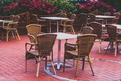 Empty chairs and table at sidewalk cafe