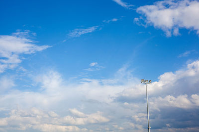Low angle view of street light against blue sky