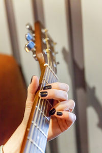 Cropped image of man playing guitar