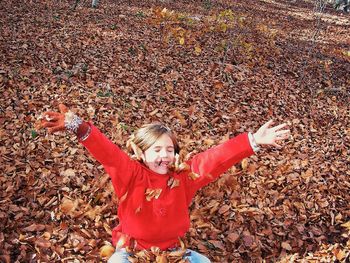 Portrait of a smiling young man with arms outstretched