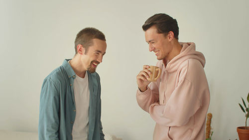 Smiling gay couple at home