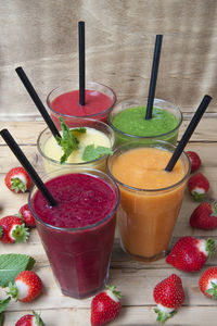 Fresh fruits with strawberries in glass on table