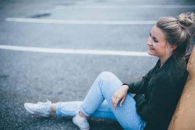 High angle view of woman sitting on road