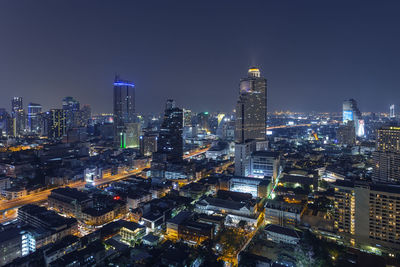 Illuminated cityscape against sky at night