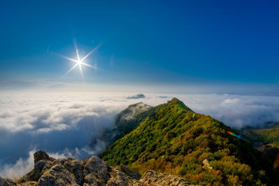 Scenic view of mountains against blue sky