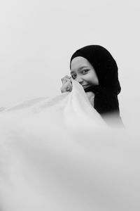 Portrait of a beautiful young woman over white background