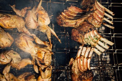 High angle view of meat on barbecue grill