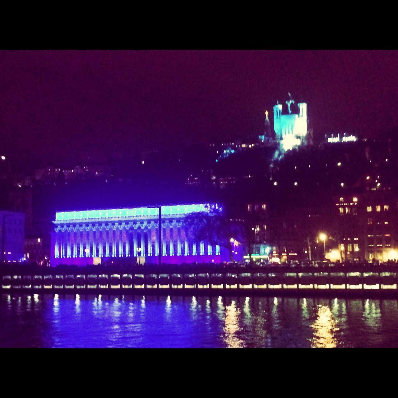 illuminated, night, water, architecture, building exterior, built structure, waterfront, reflection, river, sea, city, transfer print, auto post production filter, sky, lighting equipment, clear sky, outdoors, light, cityscape, dusk