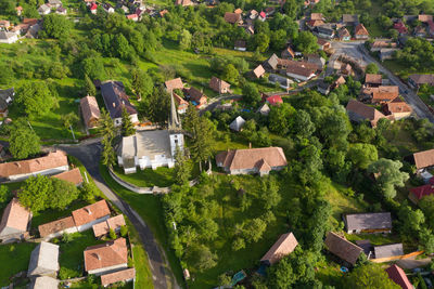 Aerial drone point of view of a whitewashed protestant church in manastireni, transylvania, romania