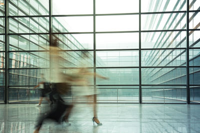 Blurred motion of people walking in airport