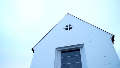 Low angle view of houses against clear blue sky