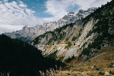 Low angle view of mountain against cloudy sky