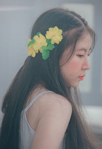 Close-up of woman wearing flowers on hair