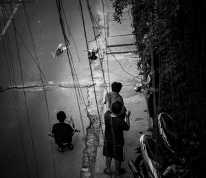 Rear view of people walking on plants