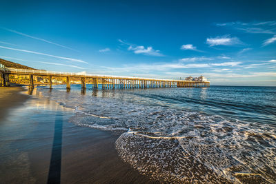 Pier over sea against sky