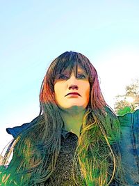 Close-up portrait of young woman against clear sky