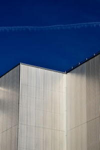 Low angle view of building against blue sky