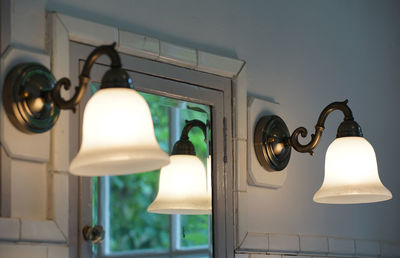 Low angle view of illuminated lamp hanging on ceiling