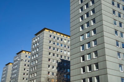 Low angle view of buildings against clear blue sky