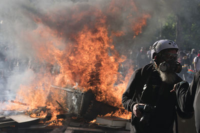 Reflection of man with fire on barbecue grill