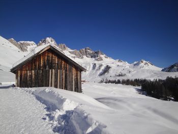 Snow covered landscape against sky