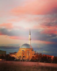 Built structure against cloudy sky at sunset