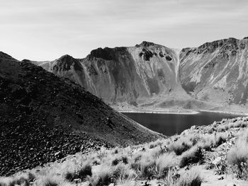 Lake amidst mountains against sky