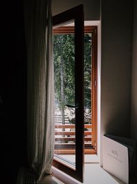 Trees seen through window of house