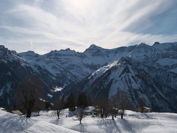 Scenic view of snow covered mountains against sky