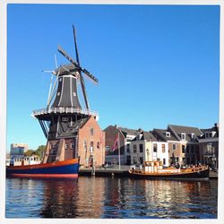 Traditional windmill against clear blue sky