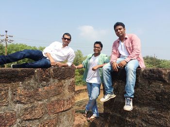 Portrait of male friends at historic building