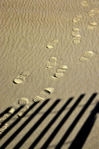 High angle view of footprints on sand