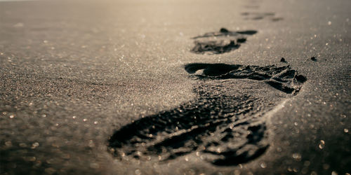 High angle view of wet sand on road