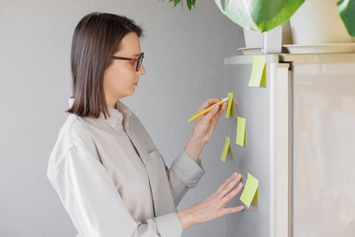 Side view of young woman looking at home