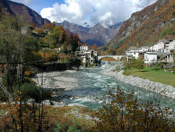 Scenic view of building by mountains against sky