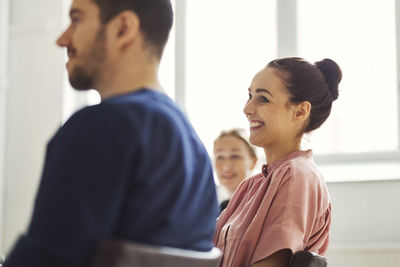 Smiling businesswoman with colleagues in meeting room