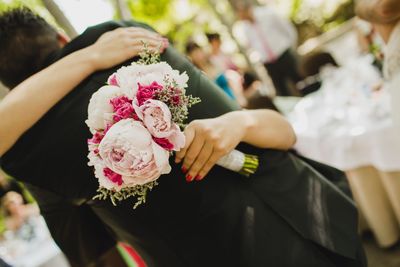 Midsection of woman holding flower bouquet