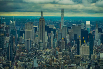 Aerial view of modern buildings in city against sky