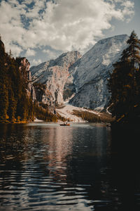 Scenic view of lake by mountains against sky