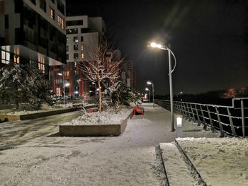 Illuminated buildings in city at night during winter