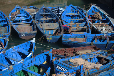 Stack of fishing boats moored in water